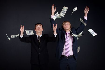 Businessmans and money. On black background.の写真素材