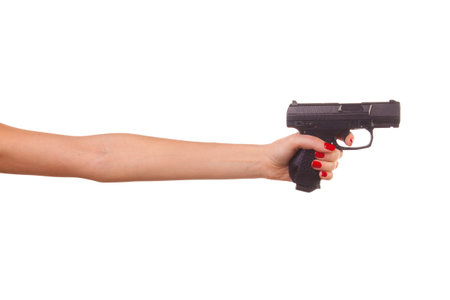 Woman's hand with a gun. Isolated on white.の写真素材