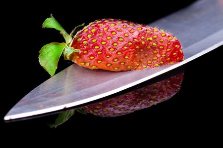 Cut strawberries. Isolated on black.の写真素材