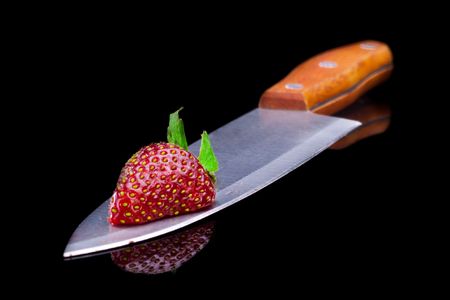 Cut strawberries. Isolated on black.の写真素材