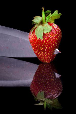 Cut strawberries. Isolated on black.の写真素材