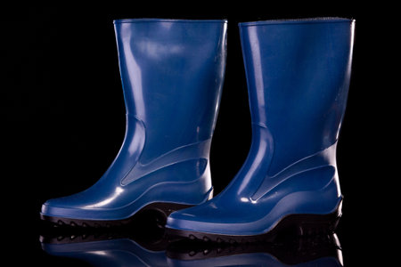 Woman gumboots. Isolated on black.の写真素材