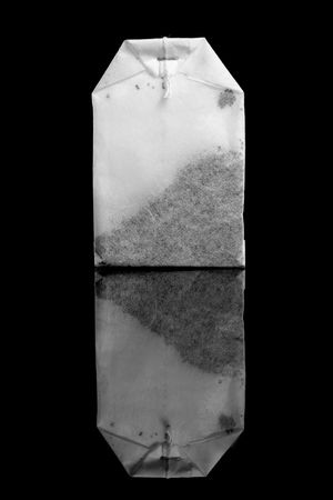The tea bags isolated on black.の写真素材