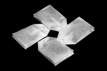 The tea bags isolated on black.の写真素材