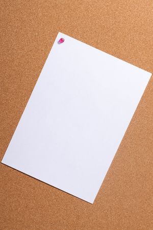 Paper with push pins on cork board. Closeup.の写真素材