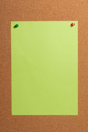 Paper with push pins on cork board. Closeup.の写真素材