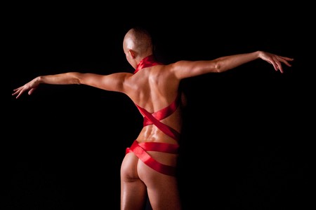 Beautiful bald woman. On black background.の写真素材