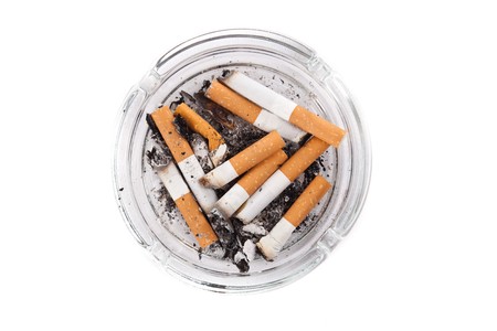 Ashtray full of cigarettes. Isolated on white.の写真素材