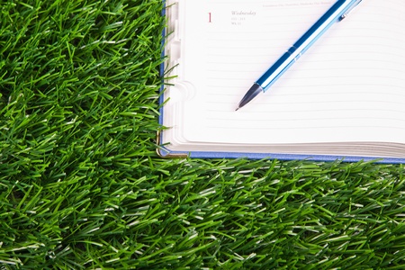 Notebook in the grassの写真素材