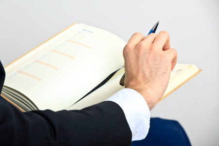 Hand and notebook. Close upの写真素材
