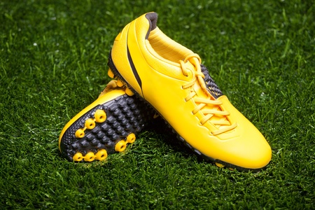 Pair of soccer shoes on grass fieldの写真素材