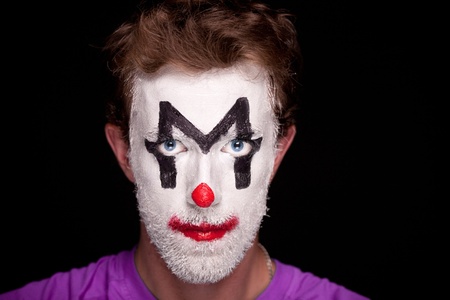 A man with clown makeup on his faceの写真素材