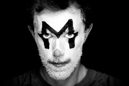 A man with clown makeup on his faceの写真素材
