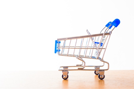 shopping carts on the wooden floor. isolated on whiteの写真素材