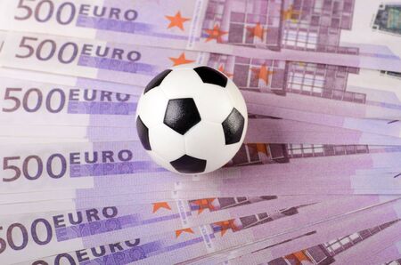 Soccer ball on background of euro banknotes の写真素材