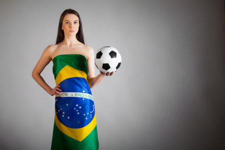 woman in the Brazilian flag on the gray backgroundの写真素材
