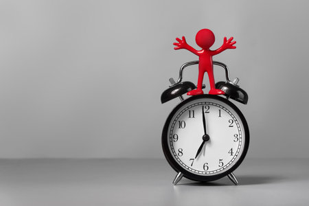 Red man and an alarm clock  The concept of time 