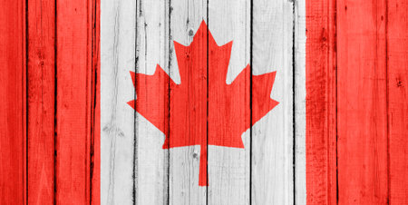 The Canadian flag painted on a wooden fenceの写真素材