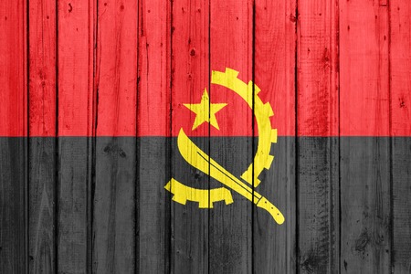 The Angolan flag painted on a wooden fenceの写真素材