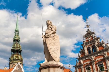 A statue of Riga s patron saint, St Roland, stands between the House of Blackheads and the Town Hall の写真素材