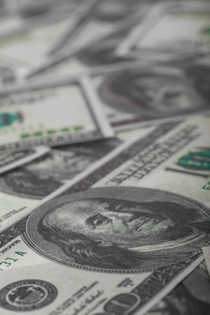 One hundred US dollars bills pile. Selective focus