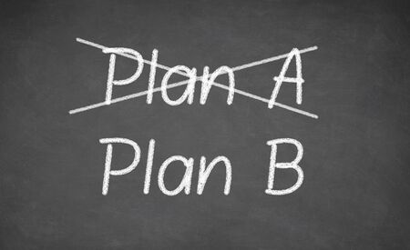 Crossing out Plan A and writing Plan B on chalkboardの写真素材