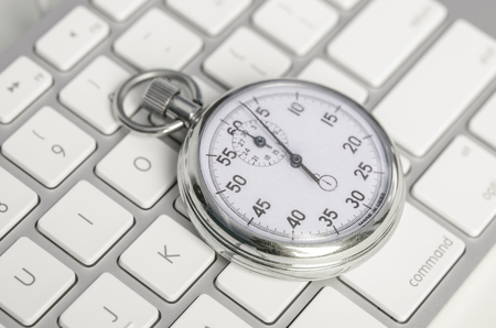 Close up of analog stopwatch on keyboardの写真素材