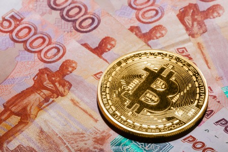 One Bitcoin on Russian rubles banknotes.の写真素材