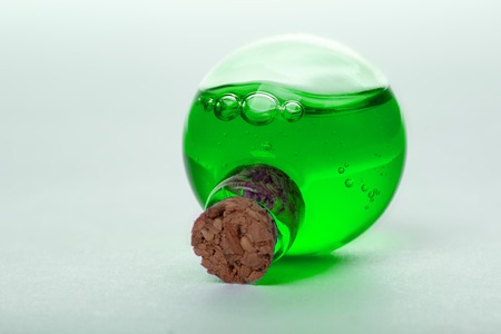 green liquid in old style vialの写真素材