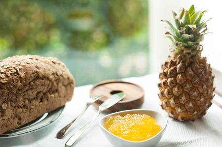 Pineapple Jam with bread on the tableの写真素材