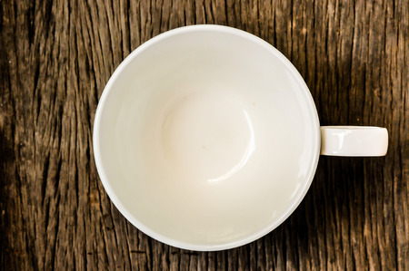 Cup of coffee on a wooden table, no coffee, still lightの写真素材