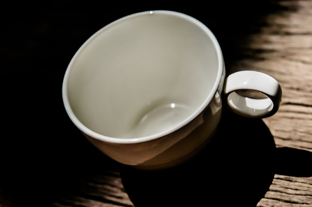 cup of black coffee empty, on the wooden table backgroundの写真素材