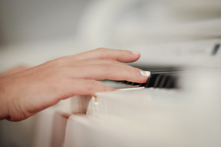Hand playing on digital piano. Close-up. Small depth of field.の写真素材