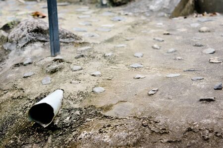 drainpipe in cement ground for waste of water around houseの写真素材