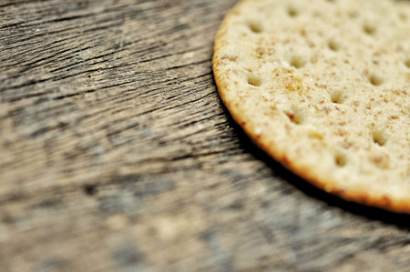 cracker in the paper wrapped on the wooden background, food concept backgroundの写真素材