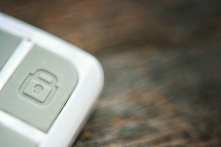 lock and unlock sign on remote and old wooden backgroundの写真素材