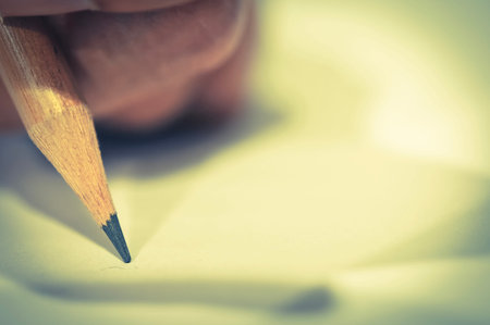 Pencil in hand on paper arts with shadows