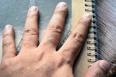 abstract background of close up hand (five fingers) on notebook, take some rest after all day work