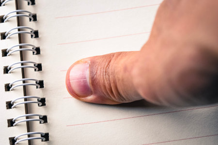 abstract background of close up thumb finger on notebook, take some rest after all day work, blurry...