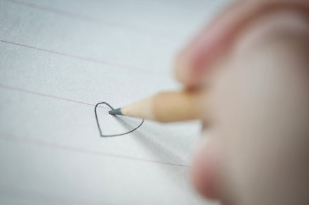 Hand with pencil write on paper notebookの写真素材