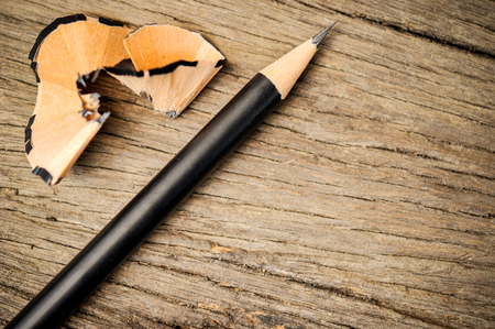 pencil and wood chips after the sharpener on the wooden floorの写真素材
