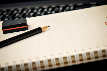 Workspace work desktop business stylish modern space wood background, pencil and eraser on notebook on wooden tableの写真素材