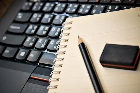 Workspace work desktop business stylish modern space wood background, pencil and eraser on notebook on wooden tableの写真素材