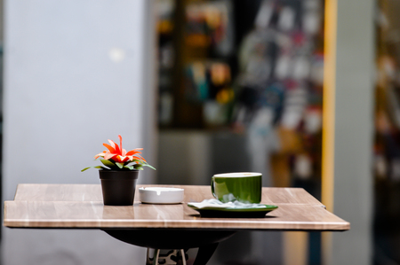 Hot Cappuccino Coffee cup on the wood table in shopの写真素材