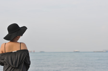 Emotional portrait of Fashion stylish portrait of pretty young hipster asian woman posing on the beach. hat, swimsuit, outdoor fashion portrait ,going crazy,elegant black hat coolの写真素材
