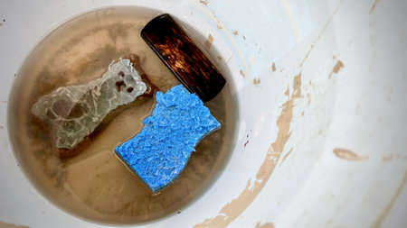 Closeup of Dirty cleaning tool after finish work, dirty floor Brush and sponge with water in bottle