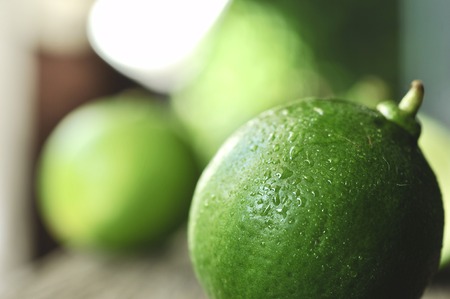 lime slices on wooden table. Detox diet, limes Backgrounds, Close up shot, fruit macro photographyの写真素材