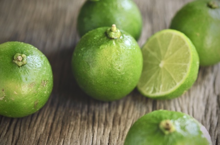 lime slices on wooden table. Detox diet, limes Backgrounds, Close up shot, fruit macro photographyの写真素材