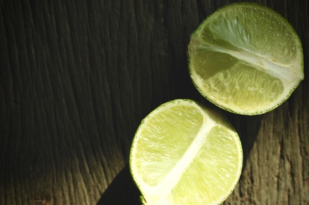 lime slices on wooden table. Detox diet, limes Backgrounds, Close up shot, fruit macro photographyの写真素材