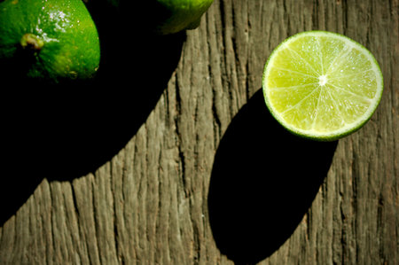 lime slices on wooden table. Detox diet, limes Backgrounds, Close up shot, fruit macro photography